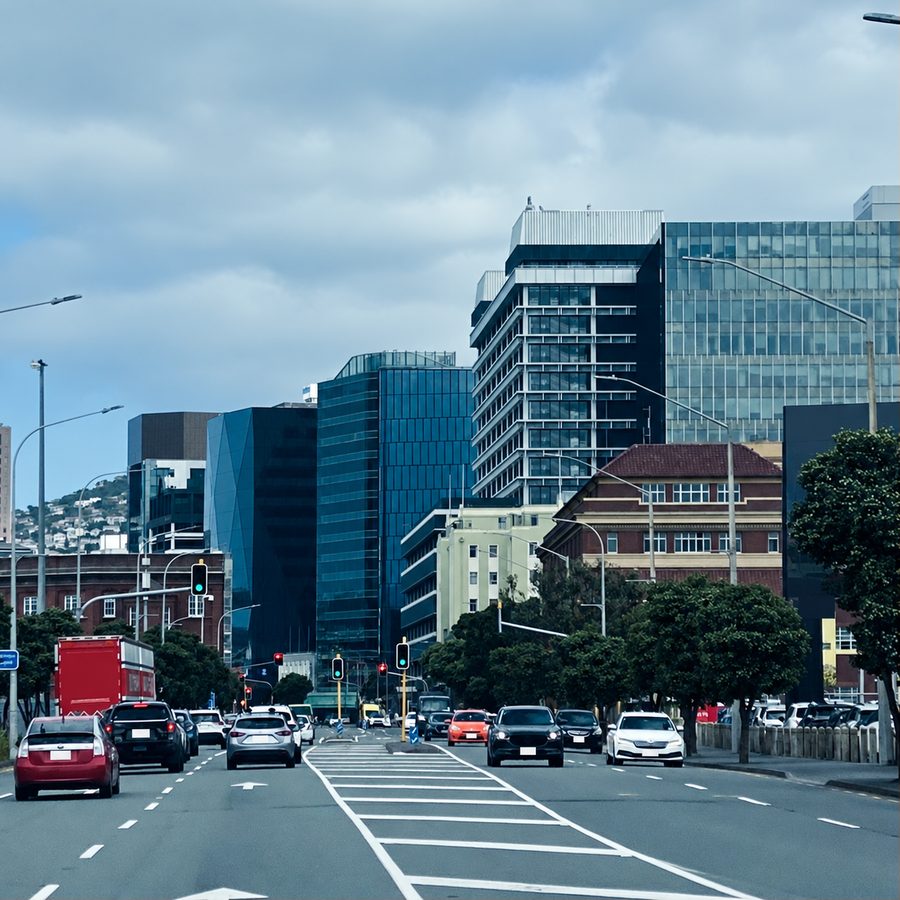Traffic heading into Wellington city with office towers and the hills behind